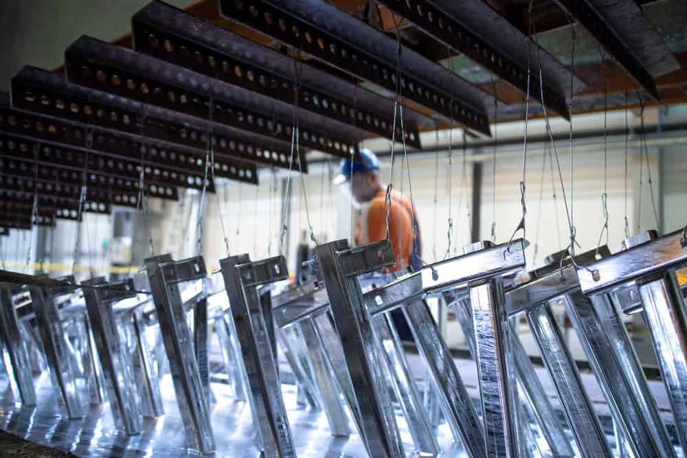 Aluminum welding process with fabricated metal frames suspended in workshop GTA